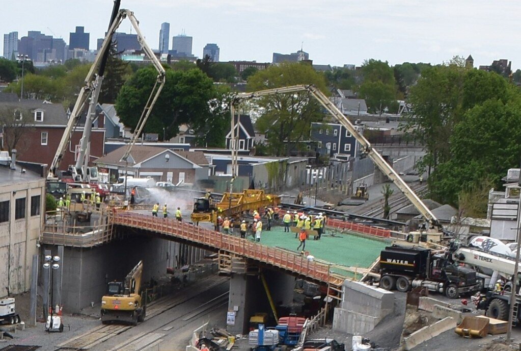 Concrete boom pumps pouring a large commercial deck